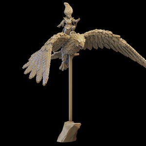 May include: A miniature figurine of a woman riding a bird with outstretched wings. The figurine is made of a light brown material and is mounted on a wooden base.