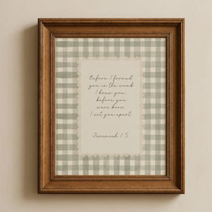 May include: A wooden framed print with a quote from Jeremiah 1:5. The text is set against a light green and white gingham pattern. The quote reads "Before I formed you in the womb I knew you, before you were born I set you apart."