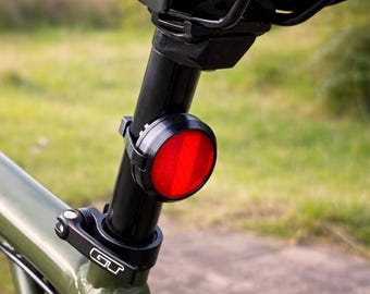 AirTag and Chipolo hidden mount reflector for bicycles & scooters, discreet tracker mounting, tool-free installation. 4 colors.