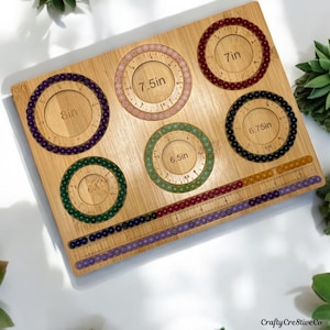 May include: A wooden bracelet sizing tool with six circular measuring guides, each displaying a different bracelet size in inches, ranging from 6.5in to 8in. The tool also includes a ruler with colored beads for measuring. The Crafty Creative Co. logo is in the bottom right corner.