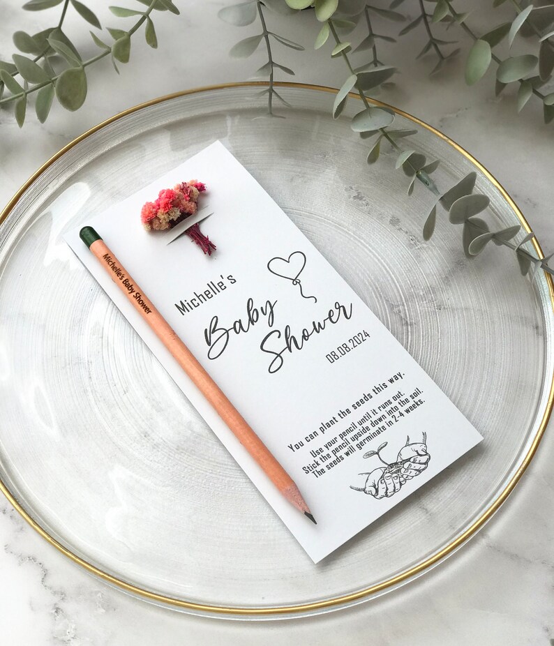 The seeded pencil is on a personalized card. There are also colorful flowers on the card.