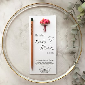 The seeded pencil is on a personalized card. There are also colorful flowers on the card.