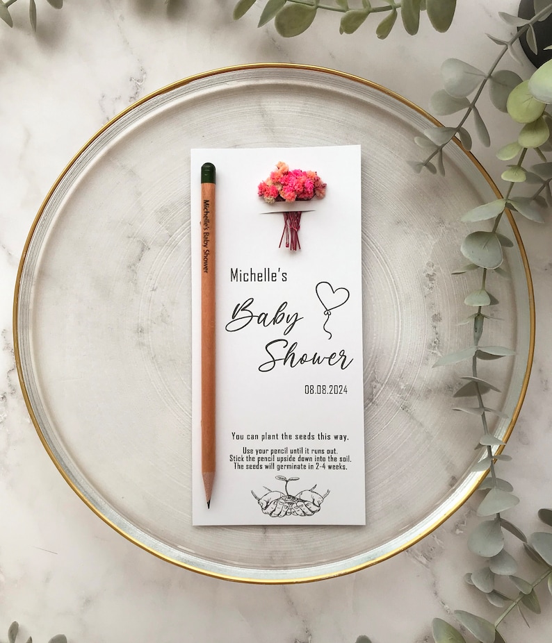 The seeded pencil is on a personalized card. There are also colorful flowers on the card.