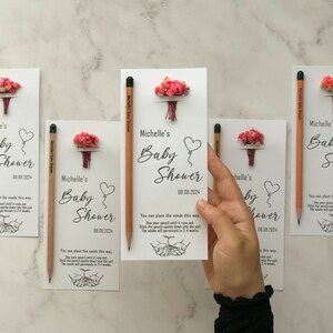 The seeded pencil is on a personalized card. There are also colorful flowers on the card.