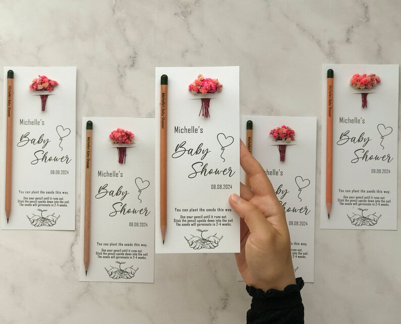 The seeded pencil is on a personalized card. There are also colorful flowers on the card.