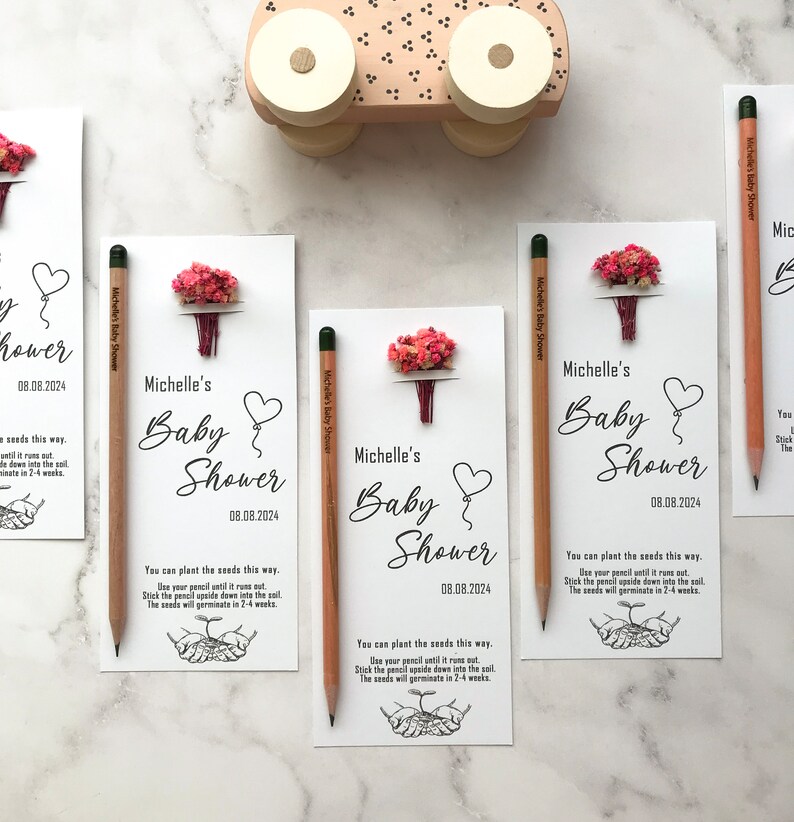 The seeded pencil is on a personalized card. There are also colorful flowers on the card.