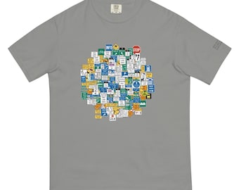 May include: A gray t-shirt featuring a circular collage of various road signs in multiple colors. The signs include "INFO", "STOP", and other directional and informational symbols. The shirt has short sleeves and a crew neck.