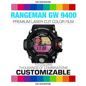 May include: Black G-Shock Rangeman GW 9400 watch with a pink and yellow digital display. The image includes text: "RANGEMAN GW 9400 PREMIUM LASER CUT COLOR FILM" and "CUSTOMIZABLE". A rainbow color gradient is at the top and bottom.