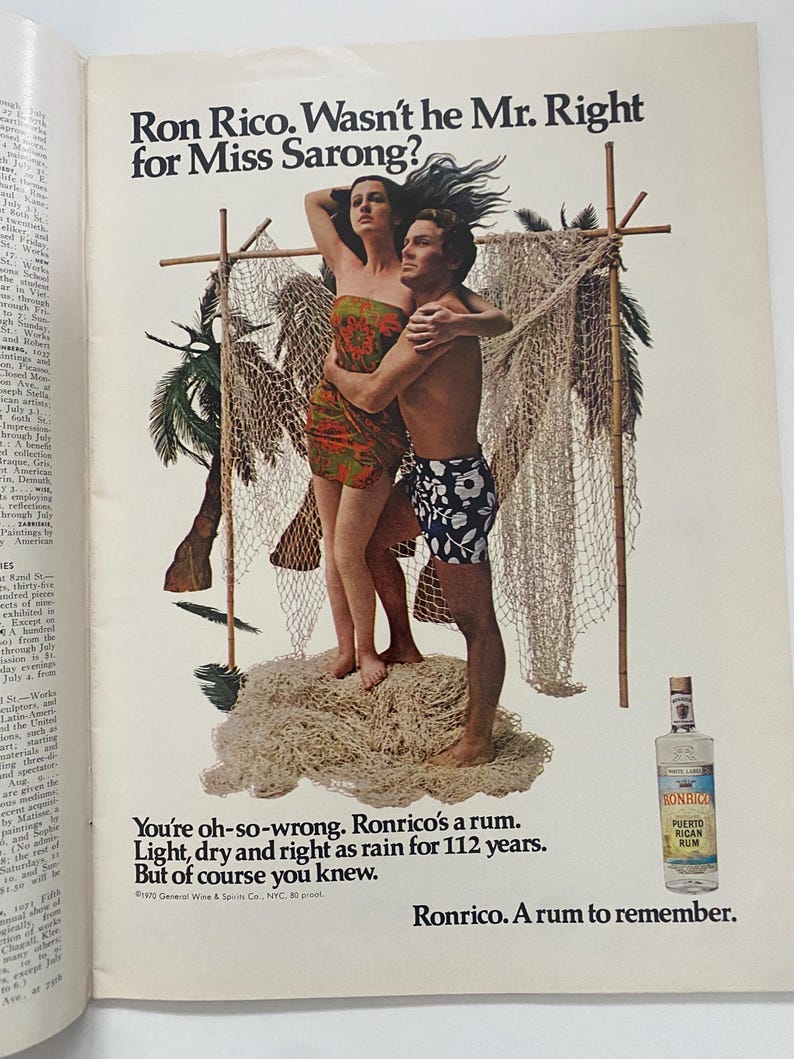 May include: A vintage advertisement for Ronrico Puerto Rican Rum featuring a couple in a tropical setting. The man is holding the woman, and they are standing on a pile of fishing nets. The text reads "Ronrico. A rum to remember." and "You're oh-so-wrong. Ronrico's a rum. Light, dry and right as rain for 112 years. But of course you knew."