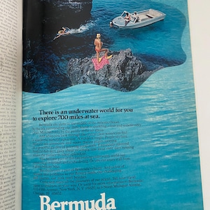 May include: A colorful travel advertisement for Bermuda, featuring a woman in a red swimsuit on a rocky outcrop, a boat with people in it, and clear blue water. The text reads "There is an underwater world for you to explore 700 miles at sea. Bermuda."