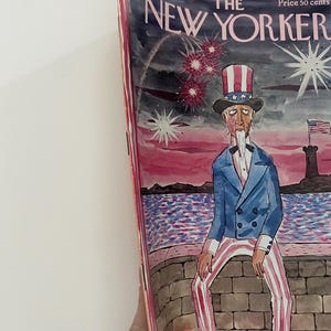 May include: The New Yorker magazine cover from July 4, 1970, features a cartoon illustration of Uncle Sam sitting on a stone wall, looking forlornly at a body of water. Fireworks explode in the sky behind him. The cover text reads "The New Yorker" and "Price 50 cents".