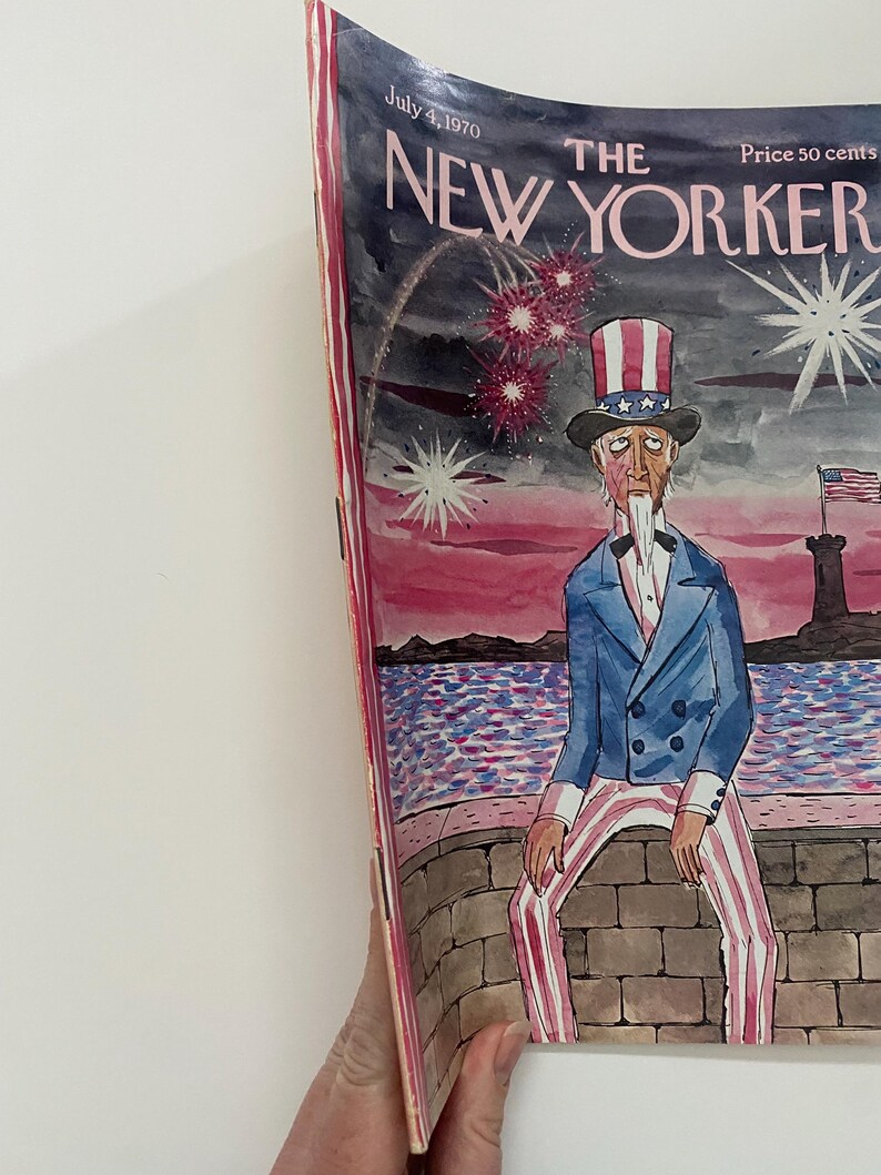 May include: The New Yorker magazine cover from July 4, 1970, features a cartoon illustration of Uncle Sam sitting on a stone wall, looking forlornly at a body of water. Fireworks explode in the sky behind him. The cover text reads "The New Yorker" and "Price 50 cents".