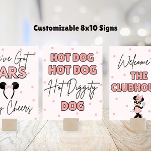 May include: Three printable 8x10 signs with a pink and white polka dot background. The signs feature the text "We've Got Ears Say Cheers", "Hot Dog Hot Dog Hot Diggity Dog", and "Welcome to The Clubhouse".