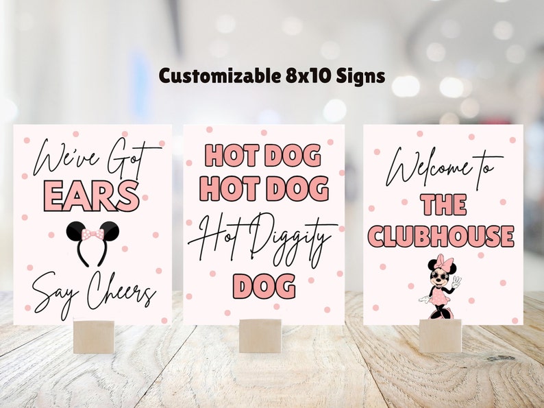 May include: Three printable 8x10 signs with a pink and white polka dot background. The signs feature the text "We've Got Ears Say Cheers", "Hot Dog Hot Dog Hot Diggity Dog", and "Welcome to The Clubhouse".