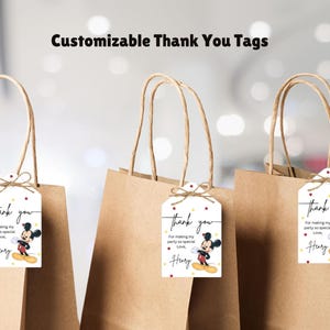 May include: Three brown paper gift bags with white thank you tags featuring a cartoon Mickey Mouse character. The tags say "Thank you for making my party so special, Love, Henry".