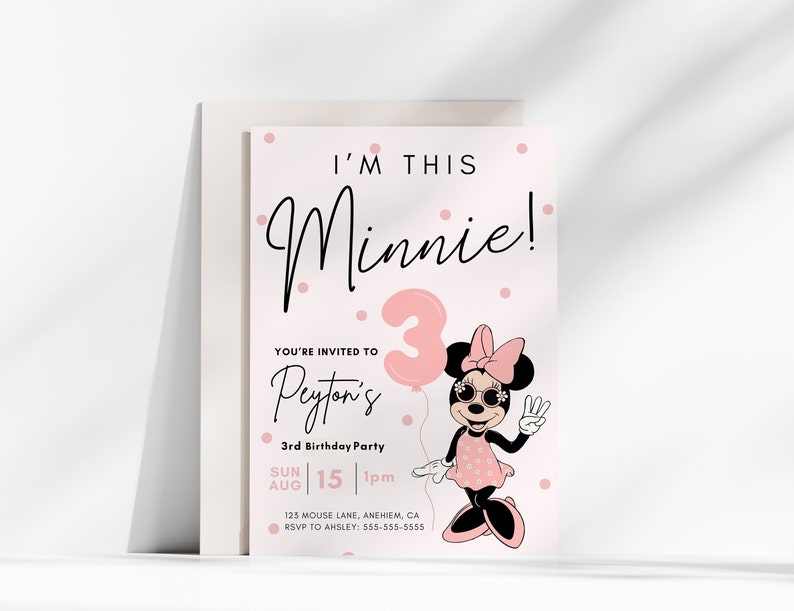 May include: A pink and white birthday invitation with a cartoon image of Minnie Mouse holding a pink balloon with the number 3 on it. The text on the invitation reads "I'm this Minnie!" and "You're invited to Peyton's 3rd Birthday Party".