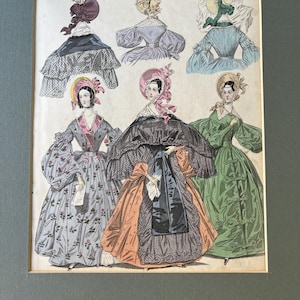 May include: A vintage fashion illustration featuring five women wearing different styles of dresses and hats. The women are depicted in a variety of poses, showcasing the latest fashion trends of the era. The illustration is printed in vibrant colors and intricate details.