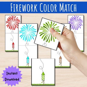 May include: A Firework Color Match educational activity set featuring rectangular cards with illustrations of colorful fireworks and rockets. Each card displays a firework burst connected by a dotted line to a matching striped rocket on green grass.