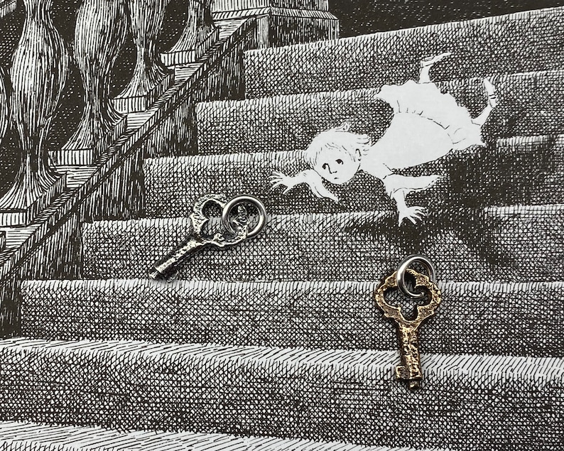 May include: Two antique skeleton keys, one gold and one silver, are placed on a black and white illustration of a staircase with a figure falling down the steps.