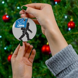 Ceramic Ornament, Detroit Lions Big Foot Christmas Tree Ornament Bigfoot Decor NFL Fan Gift Football Team Big Foot with Flag, Lions Fan Gift