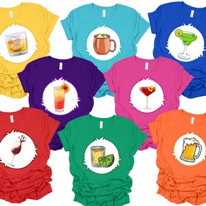 May include: Set of 8 colorful t-shirts featuring different alcoholic beverages in a cartoon style. Each shirt has a white circle with a different drink inside. The drinks include a whiskey sour, a margarita, a Moscow mule, a mimosa, a cosmopolitan, a beer, a tequila sunrise, and a rum and coke.