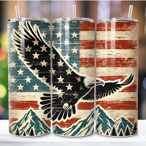 May include: Three stainless steel tumblers with a distressed American flag design and a bald eagle flying over mountains. The eagle is black and the flag is red, white, and blue.