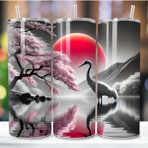 May include: Three stainless steel tumblers with a design of a red sun, a cherry blossom tree, and a crane standing in a lake. The tumblers are all black and white with a red accent.
