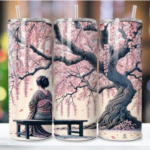 May include: A stainless steel tumbler with a design of a cherry blossom tree and a woman in a traditional Japanese kimono. The background is a soft pink and white.