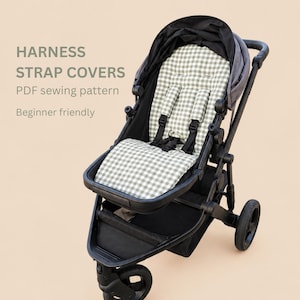 May include: A black stroller featuring a seat liner and harness strap covers with a sage green and white gingham check pattern. The text HARNESS STRAP COVERS PDF sewing pattern Beginner friendly is visible on the left side of the image.