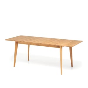 May include: A light-colored wooden dining table with a rectangular top and four angled legs. The table has a natural wood grain finish and a simple, modern design. The table is approximately 72 inches long.