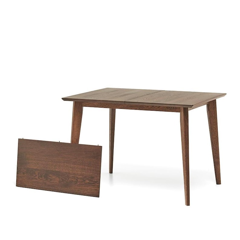 May include: A rectangular wooden dining table with a dark brown finish. The table has four tapered legs and a separate leaf. The table is approximately 48 inches long and 36 inches wide.