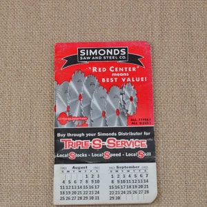 May include: Vintage Simonds Saw and Steel Co. calendar featuring a red and white design with saw blade illustrations. The calendar displays the months of August and September 1963, with the text "Red Center means Best Value!"