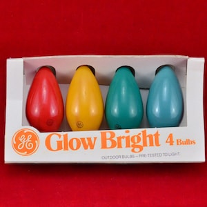 May include: A pack of four colourful light bulbs, labelled "Glow Bright 4 Bulbs" and "Outdoor Bulbs - Pre-Tested to Light". The bulbs are red, yellow, blue, and green.