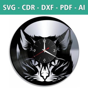 May include: A black vinyl record clock with a silhouette of a cat's face. The clock face is black with white numbers and hands.