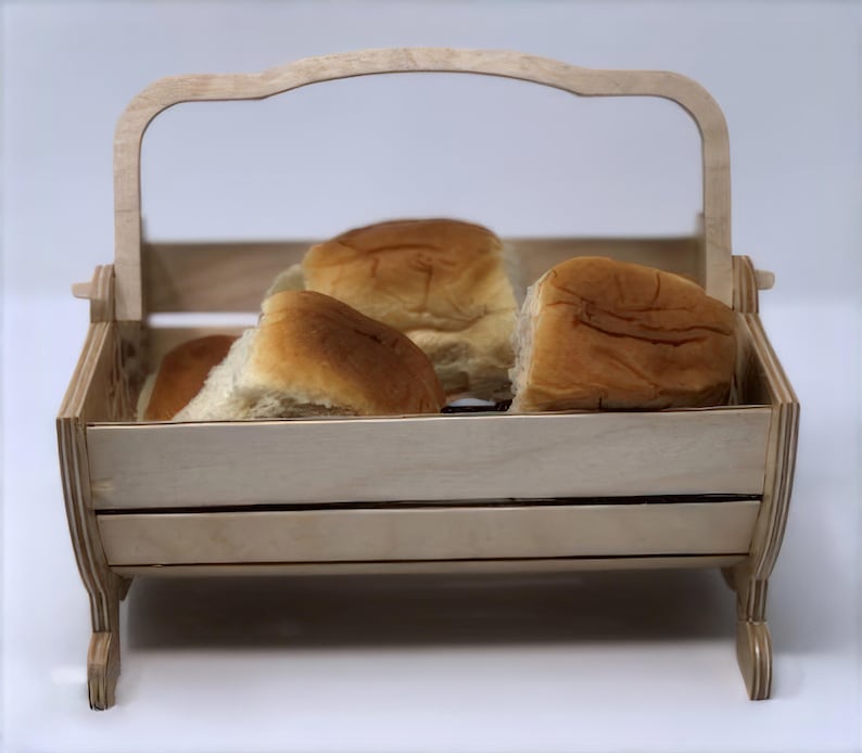 May include: A wooden bread basket with a handle, filled with four soft, golden brown rolls.