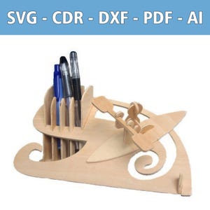 May include: A light-colored wooden desk organizer featuring a vertical pen holder section and a decorative cutout of a person in a kayak with a paddle. The top blue banner displays the text SVG - CDR - DXF - PDF - AI in white capital letters.