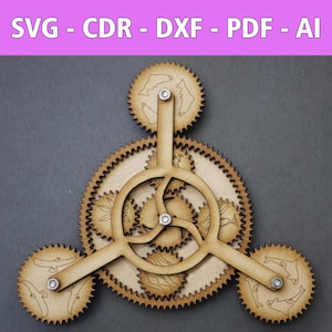 May include: A wooden gear mechanism with three arms and multiple interlocking gears. Each gear has a design of a fish on it. The gears are brown and the arms are a lighter brown.