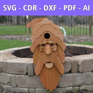 May include: A wooden birdhouse shaped like a bearded gnome with a hat. The birdhouse is made of light brown wood and has a round opening for birds. The text "SVG - CDR - DXF - PDF - AI" is displayed at the top.
