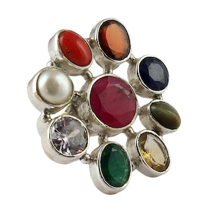 May include: A silver ring with nine gemstones set in a flower shape. The stones are red, orange, yellow, green, blue, white, and black.
