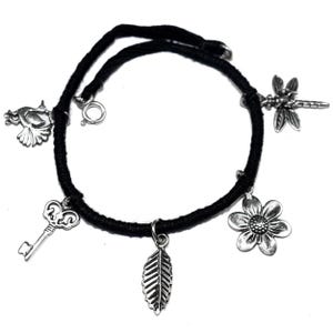 May include: Black cord bracelet with silver charms including a bird, key, leaf, flower, and dragonfly.