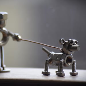 Handcrafted Metal Sculpture Of Person Walking Their Dog - Upcycled Nuts And Bolts