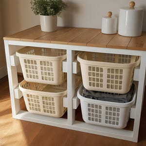 May include: White wooden storage shelf with four beige plastic baskets. The shelf has a wood top and is ideal for organizing laundry.