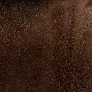 May include: A dark brown background with a fine layer of gold glitter.