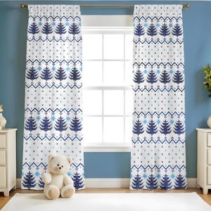 May include: White window curtains with a repeating pattern of blue Christmas trees, snowflakes, and geometric shapes. The curtains are hanging in front of a window, with a blue wall in the background. A teddy bear sits on the floor.