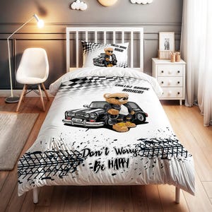 May include: White and black bedding set featuring a cartoon bear wearing sunglasses and a leather jacket, leaning against a classic car. The set includes a duvet cover and pillowcase with the text "Don't Worry - Be Happy".
