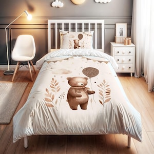 May include: A beige and brown children's bedding set featuring a cartoon bear holding a balloon. The set includes a duvet cover and pillowcase with a repeating pattern of leaves, clouds, and hearts. The bear is wearing a scarf.