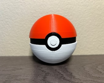 May include: A 3D printed Poke Ball toy with a red top, black band, and white bottom. The Poke Ball has a white circle with a black center on the front.