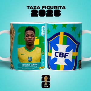 May include: A white ceramic mug with a portrait of Vin&iacute;cius J&uacute;nior in a yellow jersey, and the text "TAZA FIGURITA 2026". The mug also displays the CBF logo and FIFA branding.