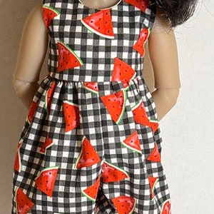 May include: A doll wearing a black and white gingham dress with red watermelon print and black and white sneakers.