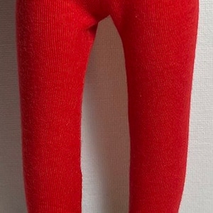 May include: Red ribbed leggings with black patent leather shoes. The shoes have a strap across the top.